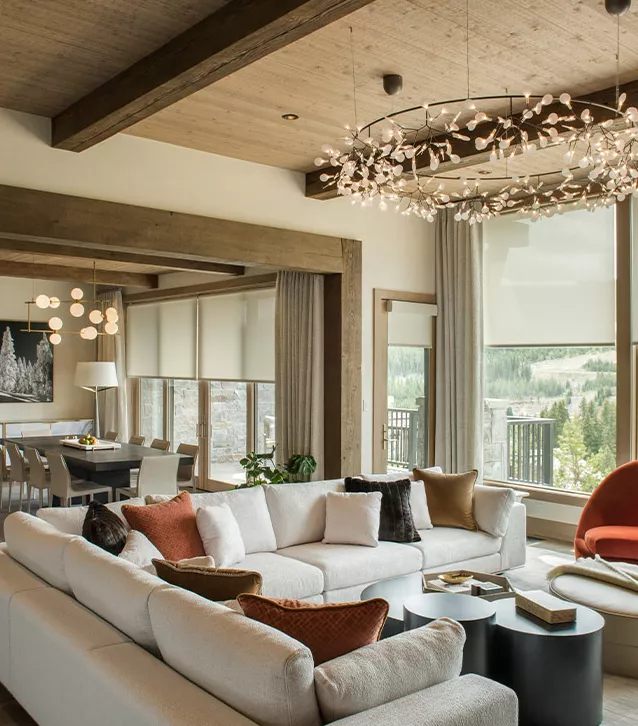 a living room with a large couch and a dining table