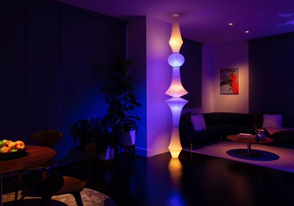 a room with a tall lamp and a couch